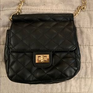 Black crossbody/over the shoulder purse with gold accents